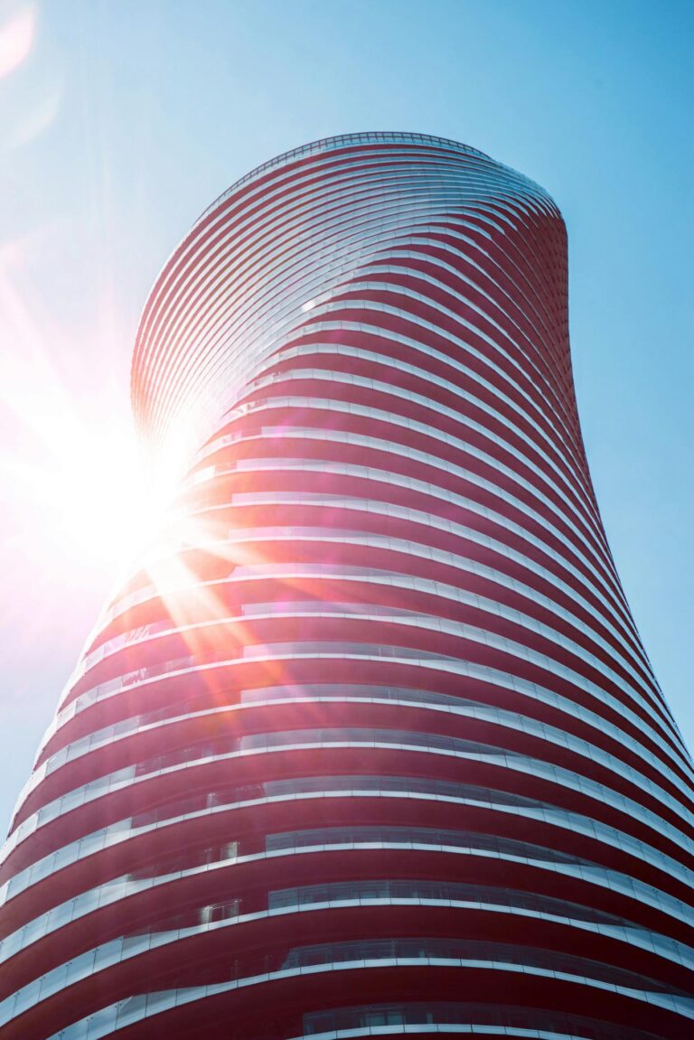 Stunning low angle shot of modern skyscraper with sun flare, Mississauga.